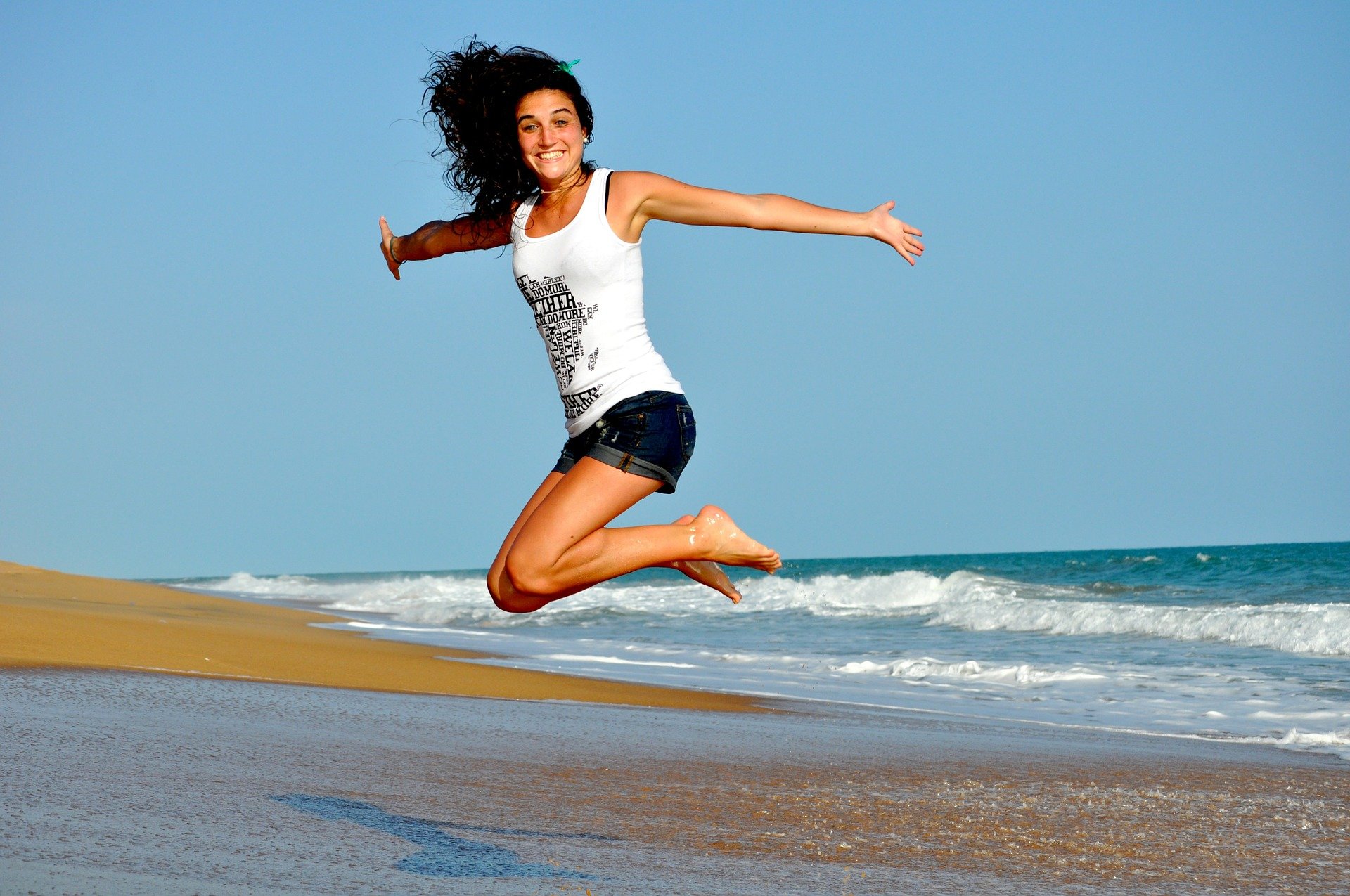 Picture of a young woman jumping into the air with her new found biohacking life enhancing products