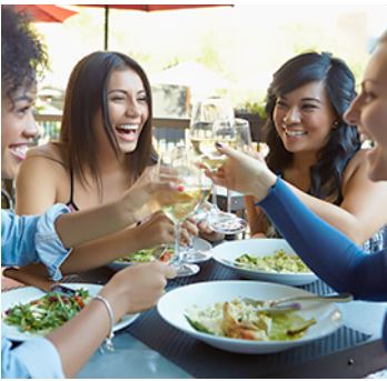 Group of ladies sharing a meal and wine to make is a magical event