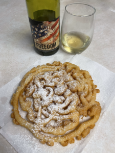 Picture of a powdered sugar covered funnel cake recipe paired with "Freedom California Chardonnay" exclusive wine