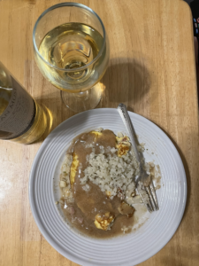 Wine and Plate of Egg Foo Yong with gravy and riced cauliflower. Keto Friendly version. 
